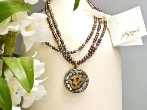 mother-of-pearl om amulet ~ long pearl necklace